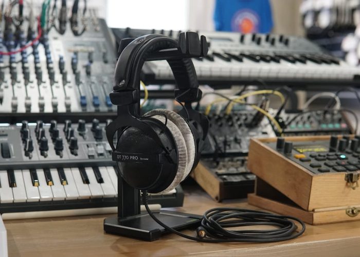 High-quality headphones and music production equipment in a modern studio setting.